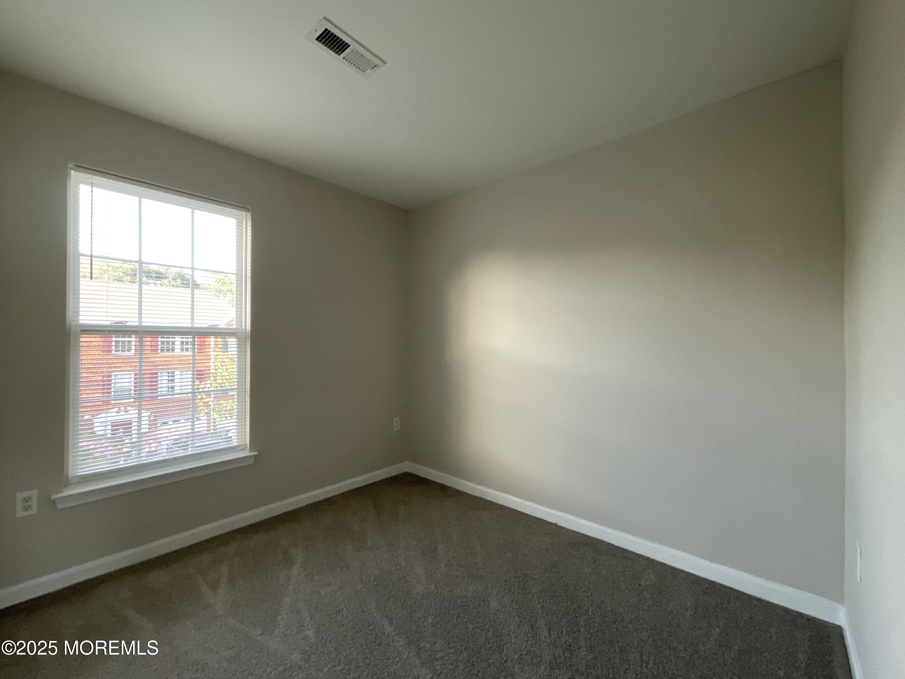 12 Abby Road, Unit 75 Farmingdale, NJ 07727 - Photo 16 of 20 an empty room with a window