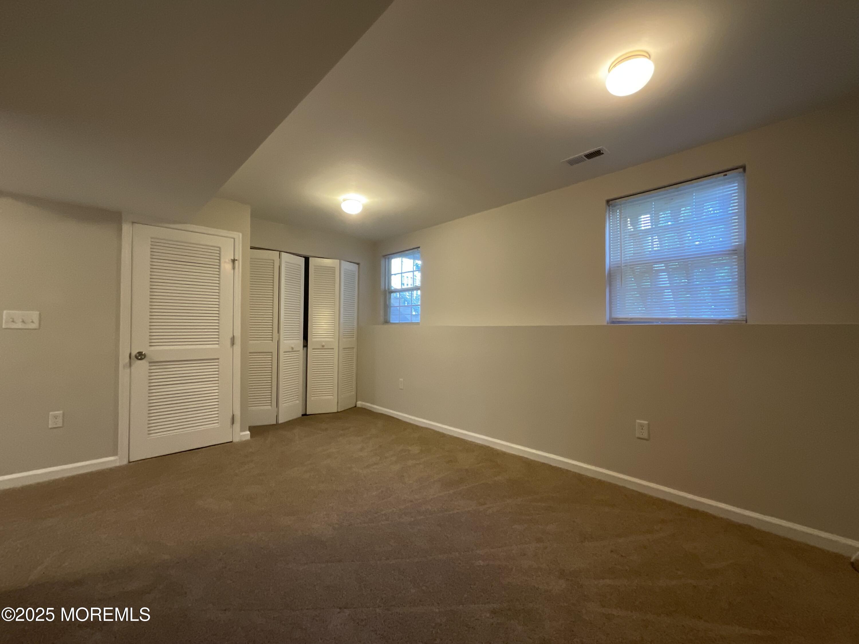 12 Abby Road, Unit 75 Farmingdale, NJ 07727 - Photo 3 of 20 an empty room with windows