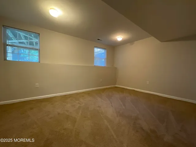 an empty room with a projector and windows