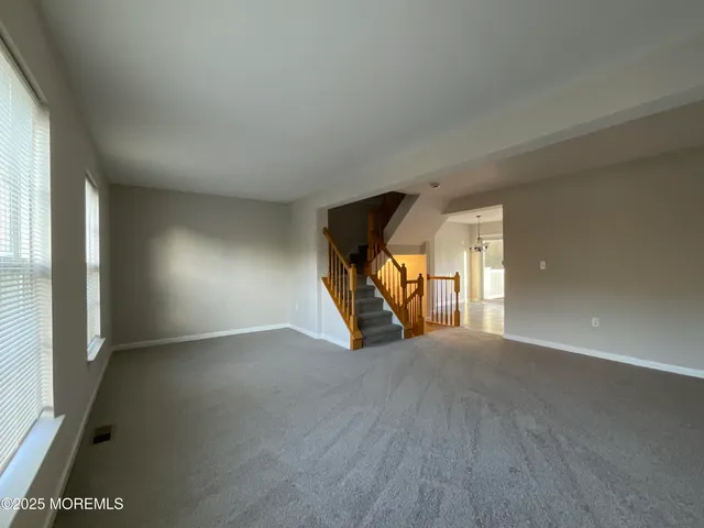 a view of a livingroom with wooden floor and a window