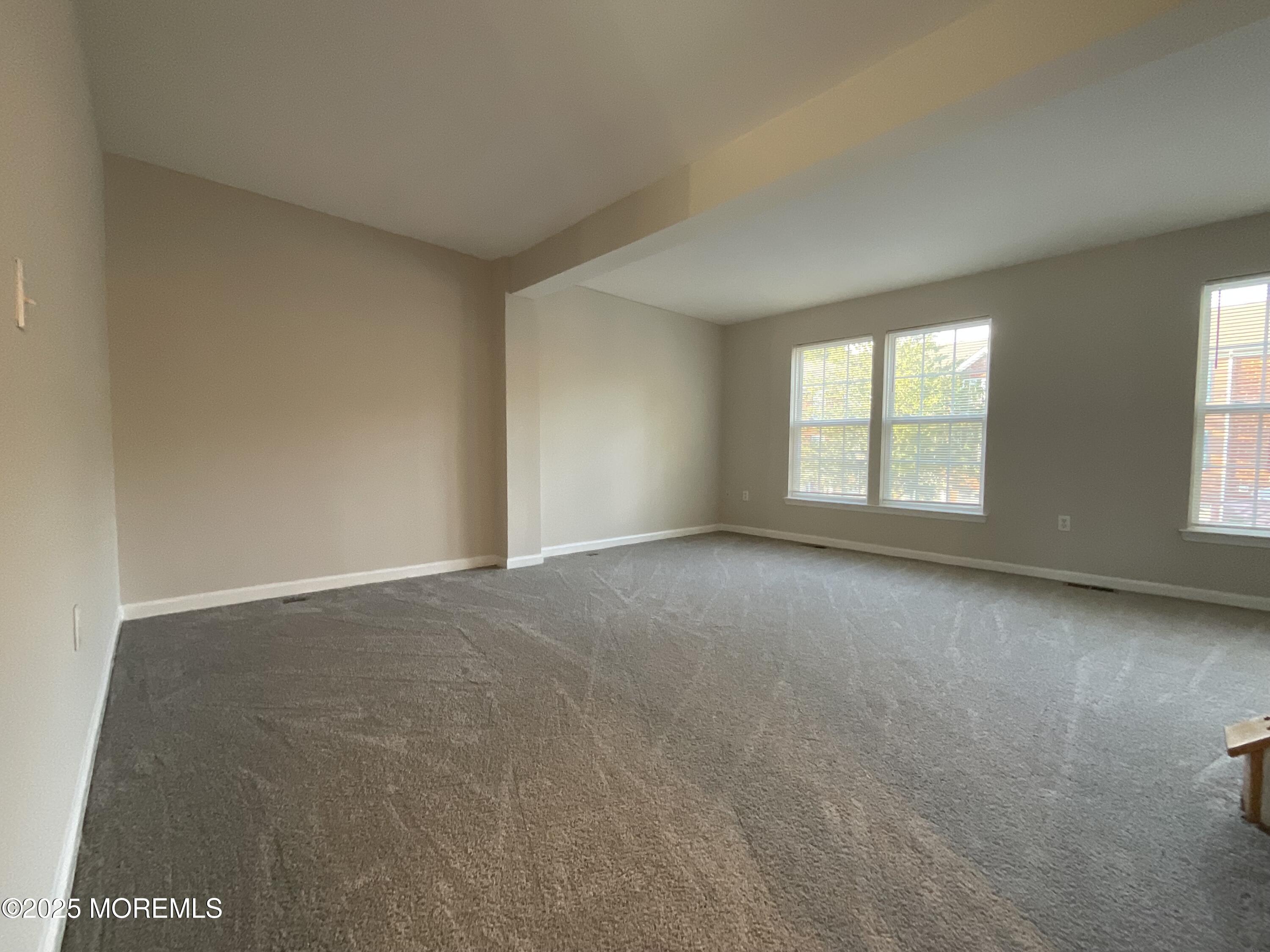 12 Abby Road, Unit 75 Farmingdale, NJ 07727 - Photo 7 of 20 an empty room with windows