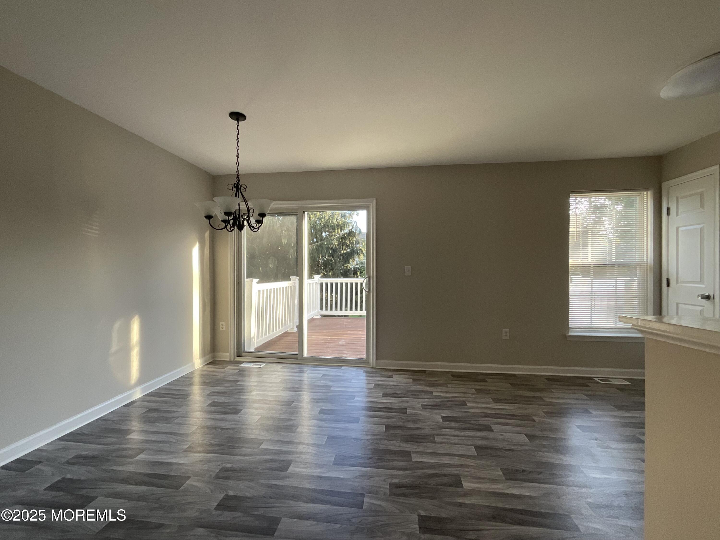 12 Abby Road, Unit 75 Farmingdale, NJ 07727 - Photo 8 of 20 a view of an empty room with wooden floor and a window