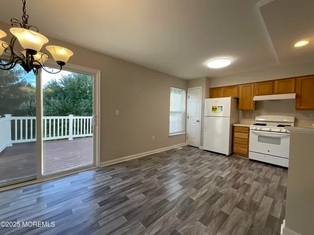 a view of a kitchen with a sink wooden floor and a window