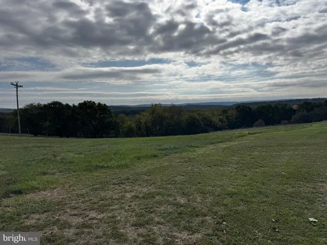 a living room with furniture and floor to ceiling window