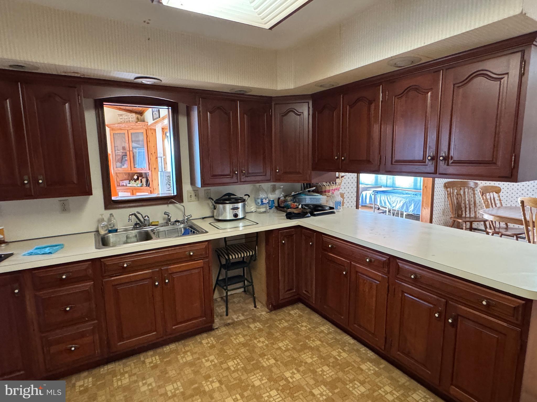 13677 Piney Ridge Road Huntingdon, PA 16652 - Photo 50 of 93 a kitchen with stainless steel appliances granite countertop wooden cabinets a sink and dishwasher with wooden floor