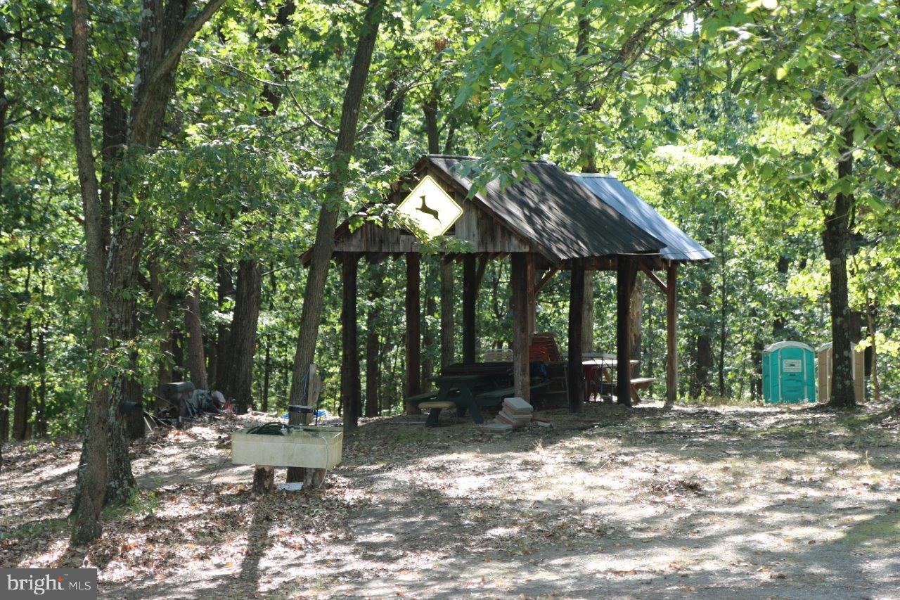 13677 Piney Ridge Road Huntingdon, PA 16652 - Photo 89 of 93 a backyard of a house with table and chairs under an umbrella