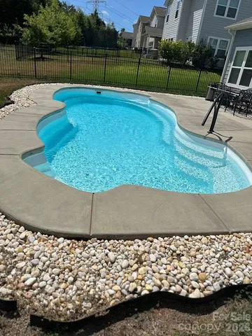 a view of swimming pool with a bench