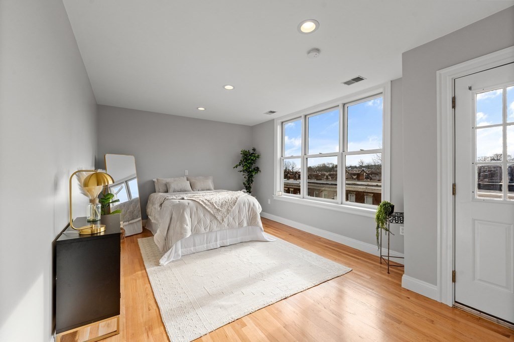 39 Leamington Road, Unit 39 Boston, MA 02135 - Photo 15 of 32 a bedroom with a bed and a large window