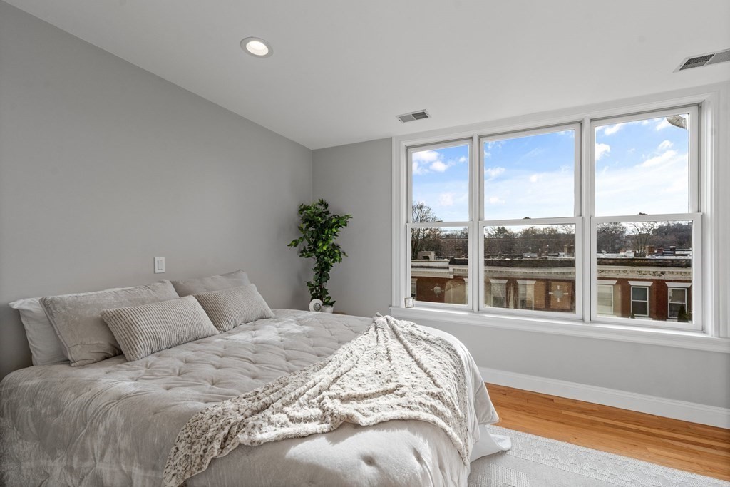 39 Leamington Road, Unit 39 Boston, MA 02135 - Photo 16 of 32 a bedroom with a large bed and a large window