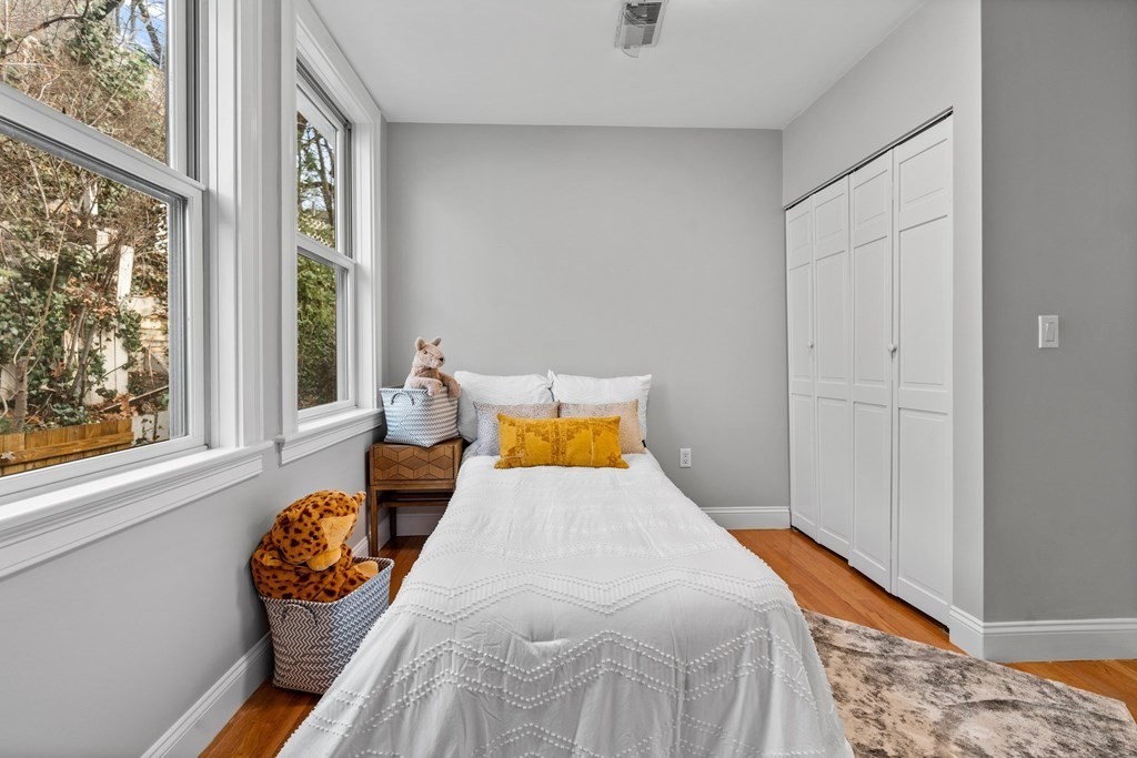 39 Leamington Road, Unit 39 Boston, MA 02135 - Photo 24 of 32 a bedroom with a bed and wooden floor