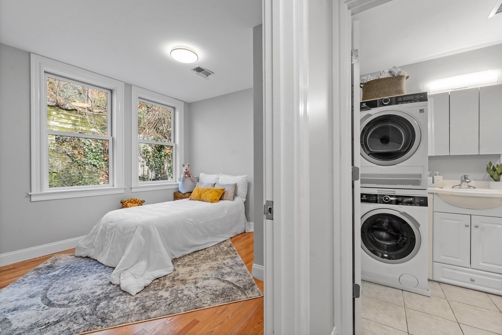 39 Leamington Road, Unit 39 Boston, MA 02135 - Photo 25 of 32 a bedroom with a washer and dryer in it