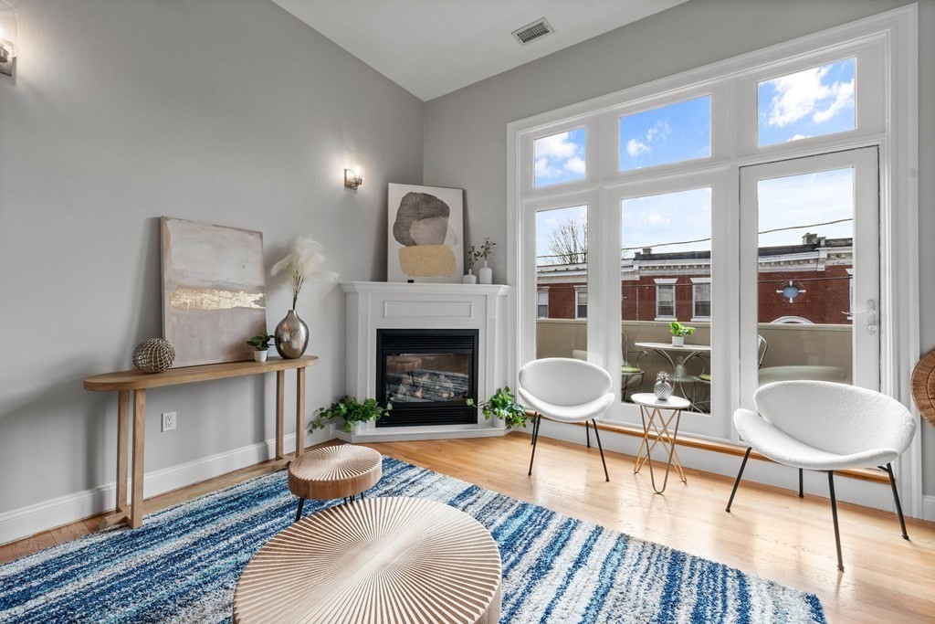 39 Leamington Road, Unit 39 Boston, MA 02135 - Photo 4 of 32 a living room with furniture a table and a fireplace