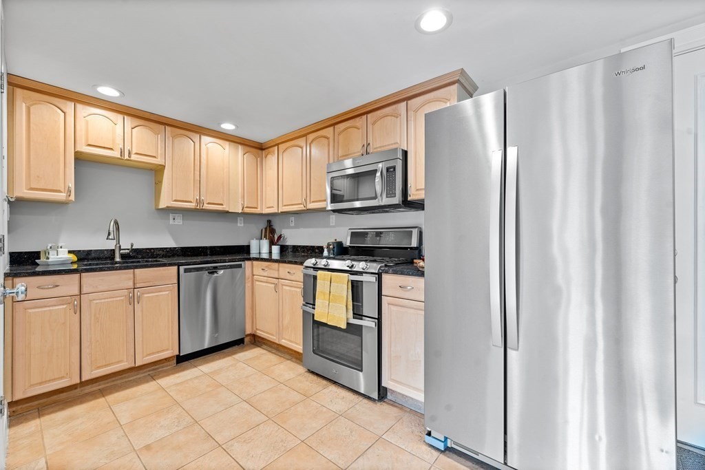 39 Leamington Road, Unit 39 Boston, MA 02135 - Photo 8 of 32 a kitchen with stainless steel appliances granite countertop a refrigerator and a stove top oven