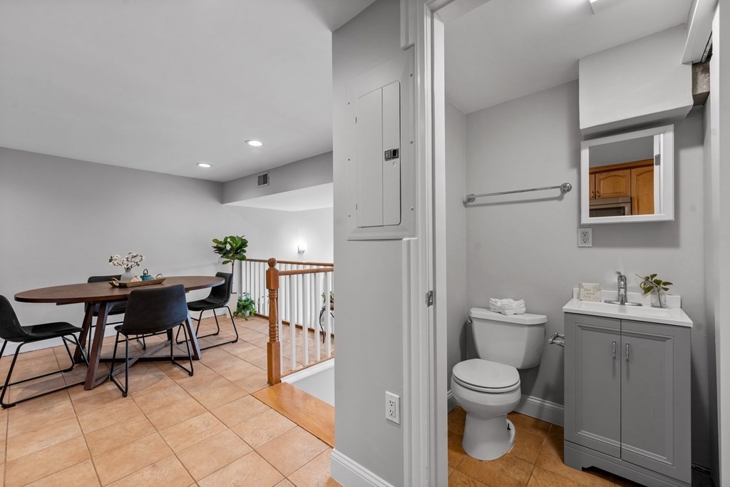 39 Leamington Road, Unit 39 Boston, MA 02135 - Photo 10 of 32 a bathroom with a toilet a sink and mirror