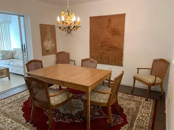 a view of a dining room with furniture and chandelier