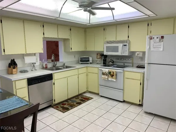 a kitchen with a sink appliances and cabinets
