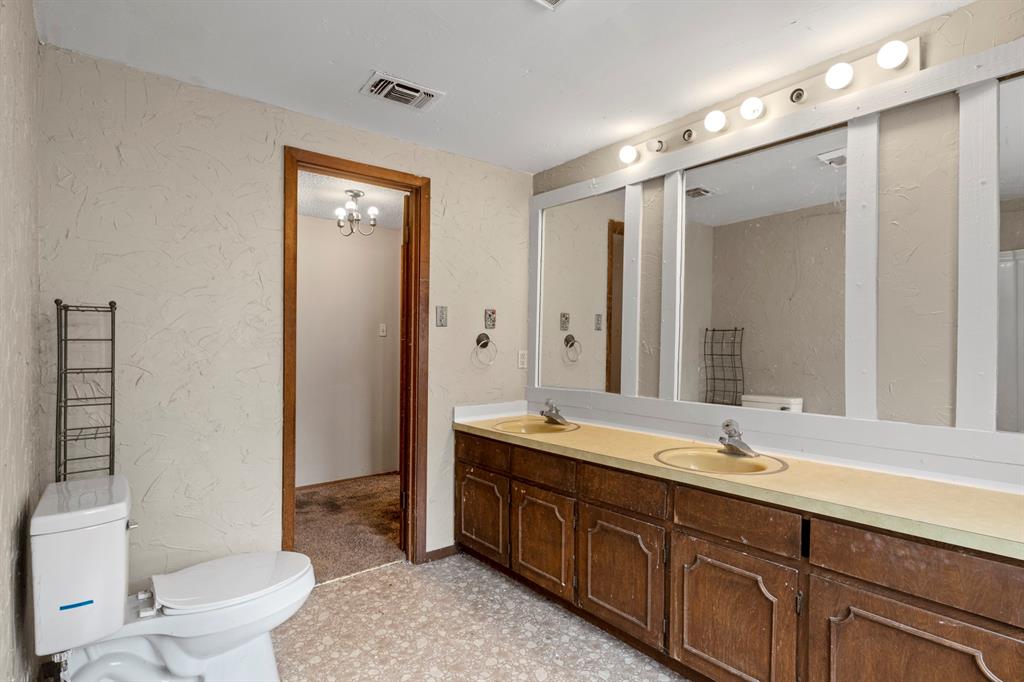 504 East 3rd Street Mount Pleasant, TX 75455 - Photo 20 of 28 a spacious bathroom with a double vanity sink mirror double and toilet