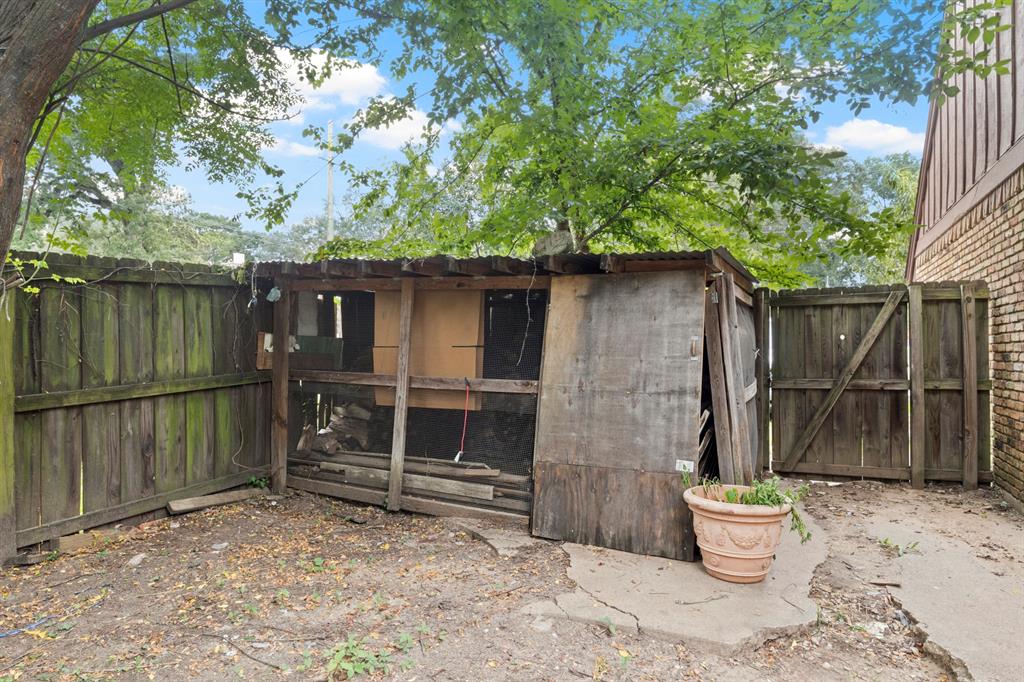 504 East 3rd Street Mount Pleasant, TX 75455 - Photo 23 of 28 a backyard of a house with a swing chair and potted plants