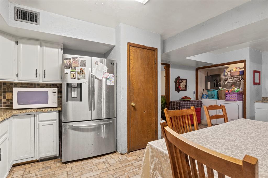 504 East 3rd Street Mount Pleasant, TX 75455 - Photo 8 of 28 a kitchen with stainless steel appliances granite countertop a refrigerator and microwave