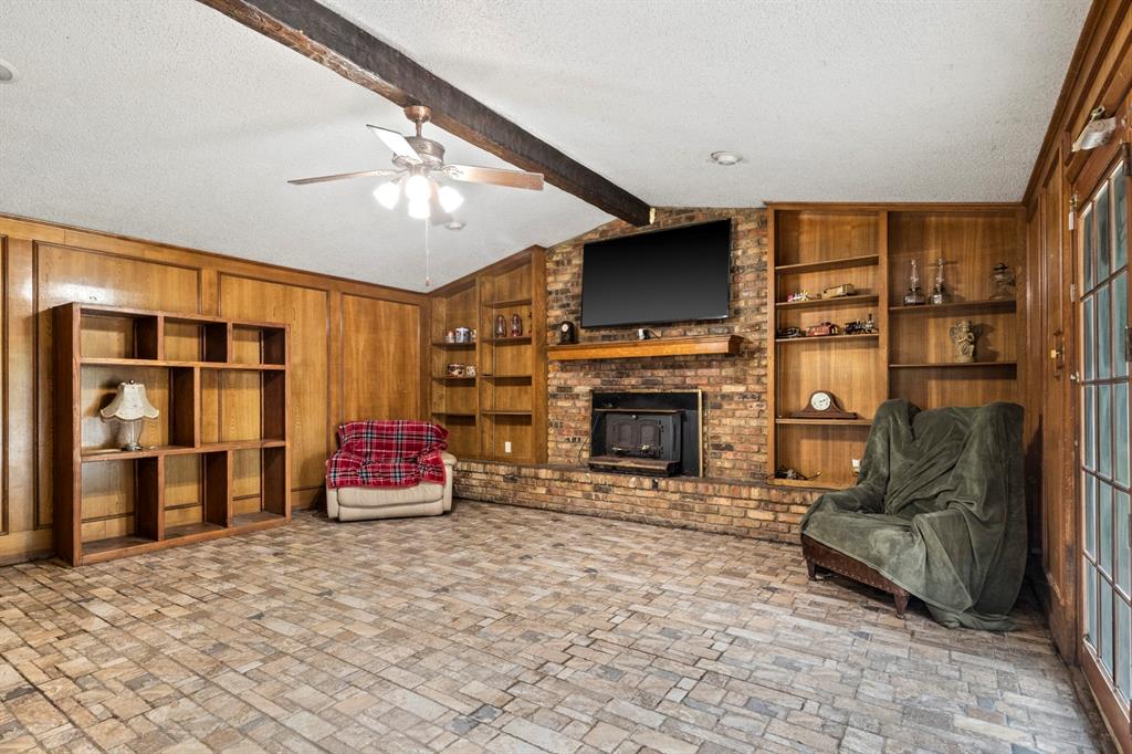 504 East 3rd Street Mount Pleasant, TX 75455 - Photo 10 of 28 a living room with furniture a flat screen tv and a fireplace