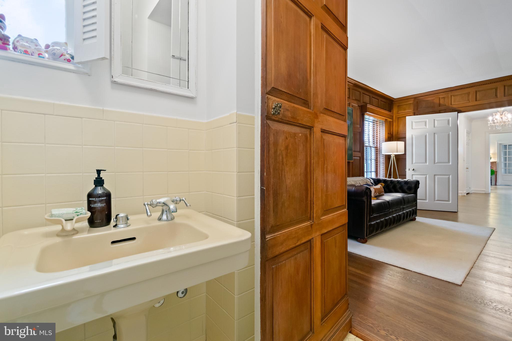 211 Lambeth Road Baltimore, MD 21218 - Photo 13 of 55 a bathroom with a sink and a mirror