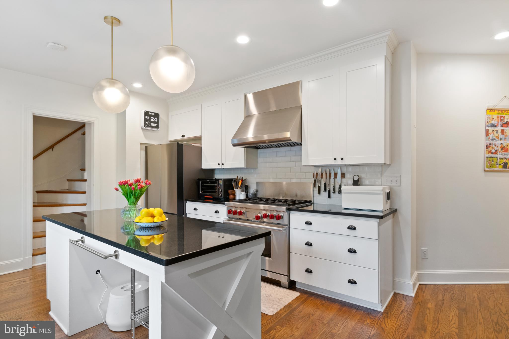 211 Lambeth Road Baltimore, MD 21218 - Photo 17 of 55 a kitchen with a sink a stove and cabinets
