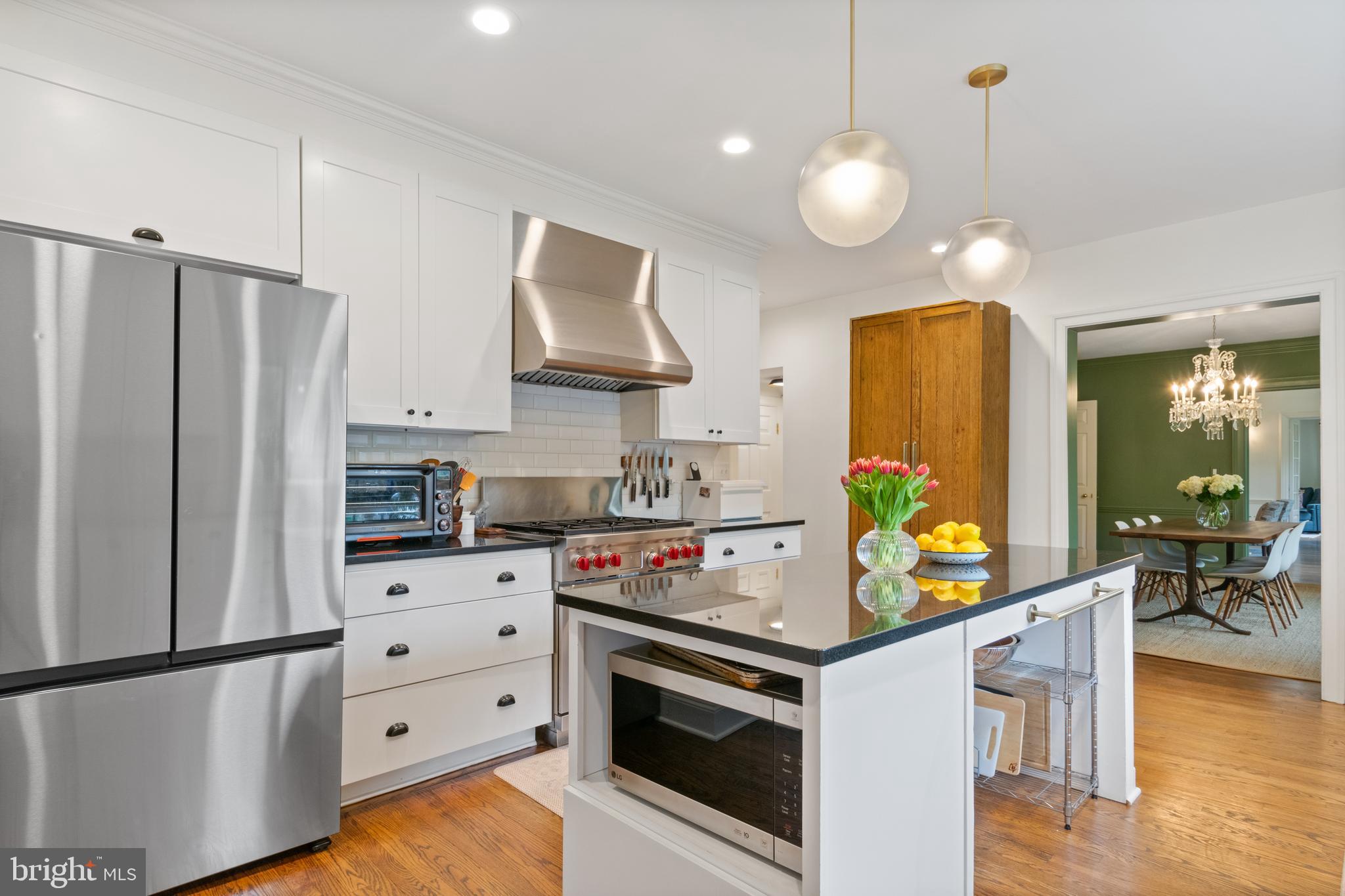 211 Lambeth Road Baltimore, MD 21218 - Photo 18 of 55 a kitchen with stainless steel appliances a stove a refrigerator and a wooden floors