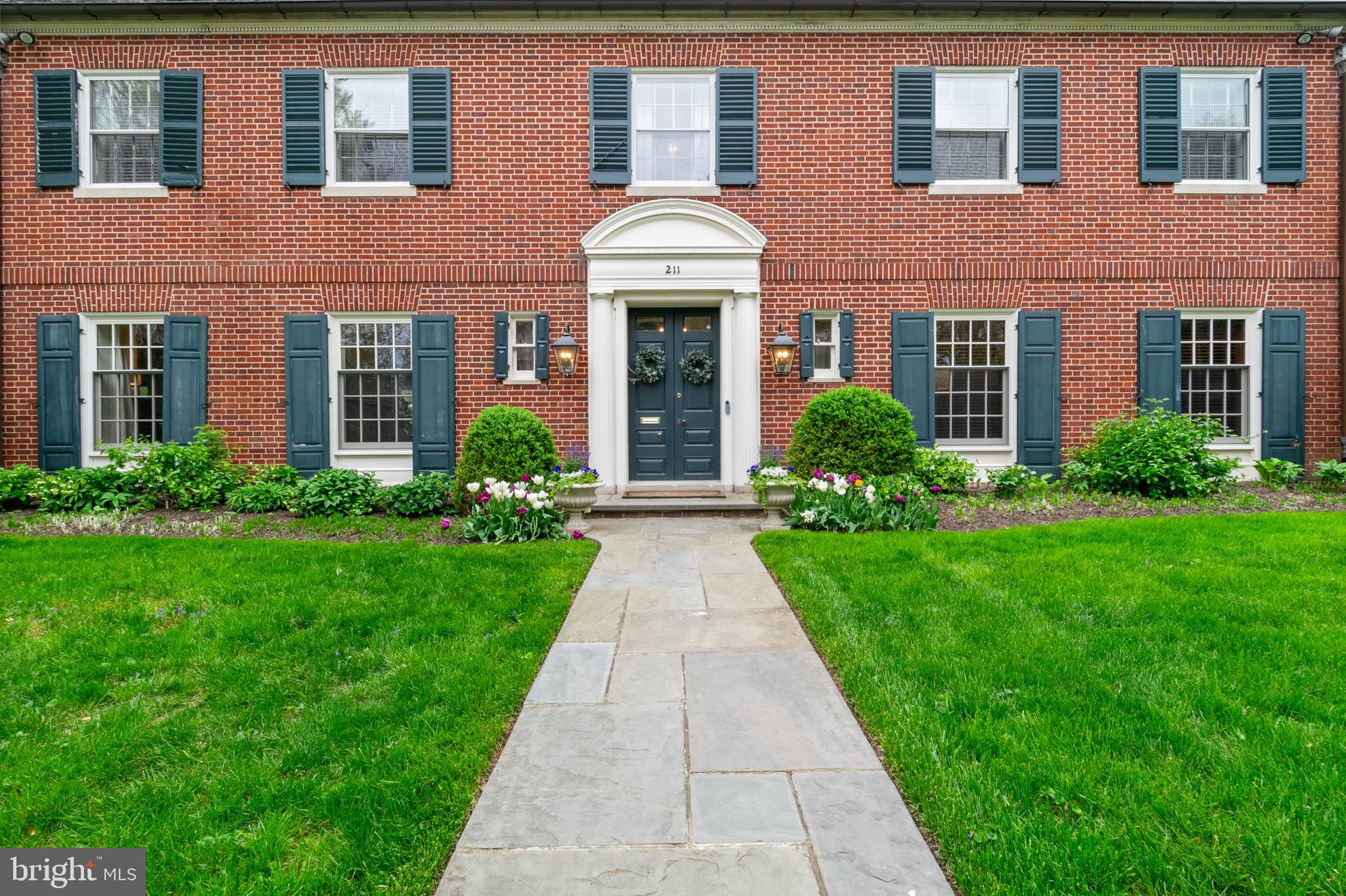 211 Lambeth Road Baltimore, MD 21218 - Photo 2 of 55 a view of a brick house with a yard