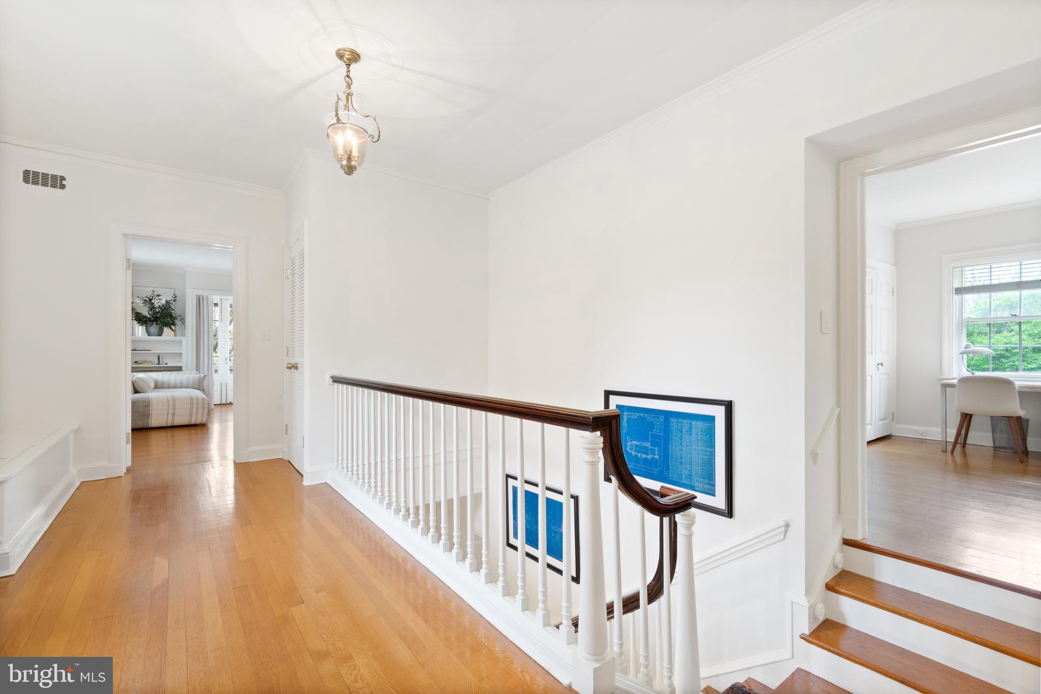 211 Lambeth Road Baltimore, MD 21218 - Photo 32 of 55 a view of a hallway with wooden floor and a bathroom