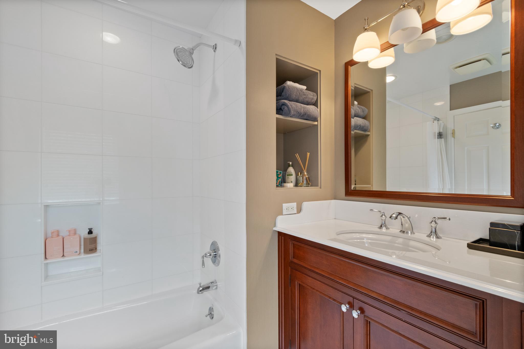 211 Lambeth Road Baltimore, MD 21218 - Photo 35 of 55 a bathroom with a sink a tub and a mirror