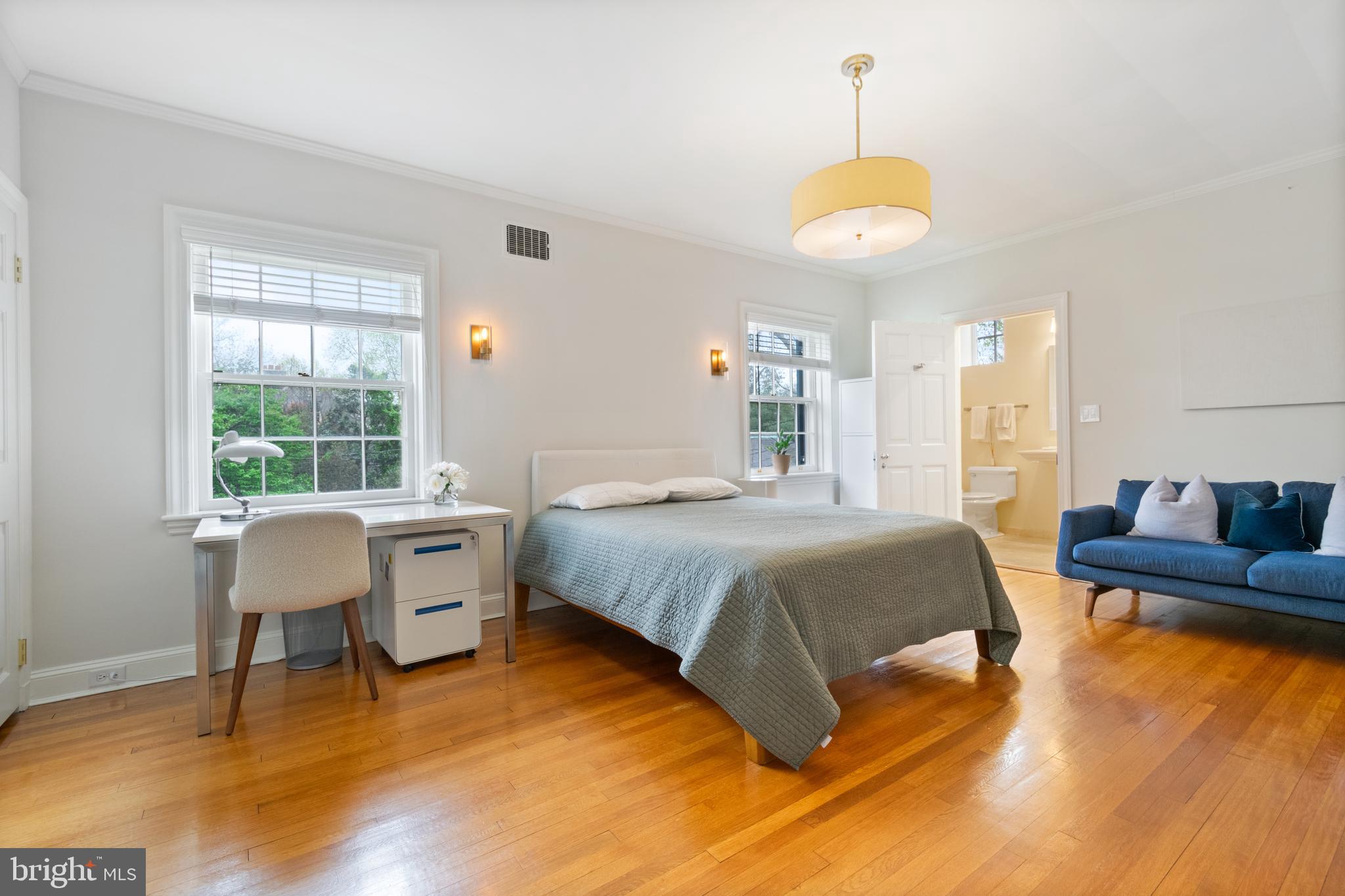 211 Lambeth Road Baltimore, MD 21218 - Photo 36 of 55 a spacious bedroom with a bed and a table in it
