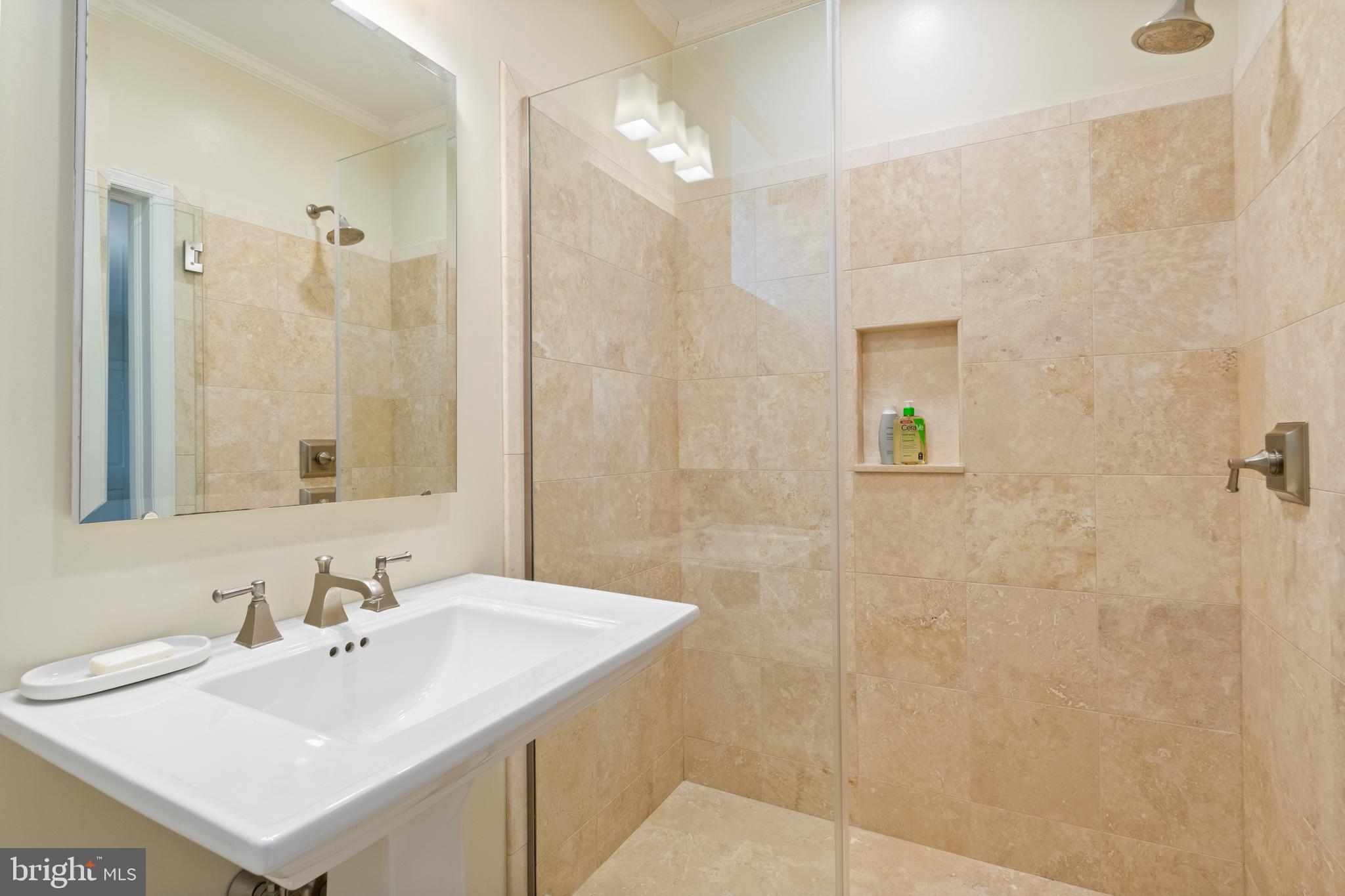 211 Lambeth Road Baltimore, MD 21218 - Photo 38 of 55 a bathroom with a sink mirror and shower