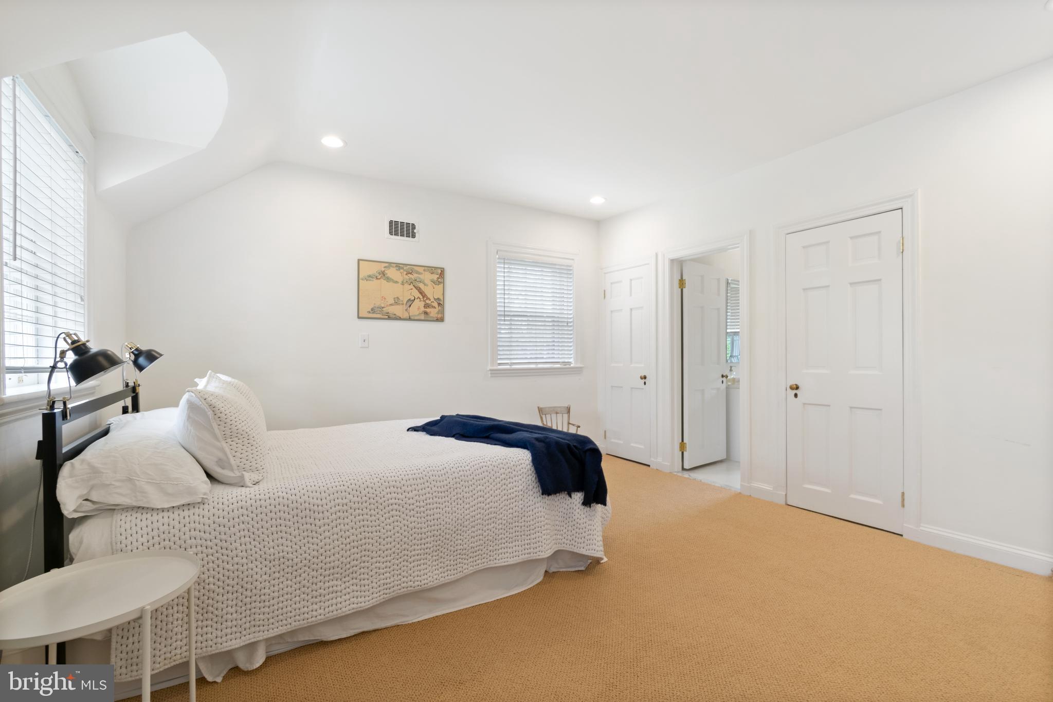 211 Lambeth Road Baltimore, MD 21218 - Photo 41 of 55 a bedroom with a bed and a lamp