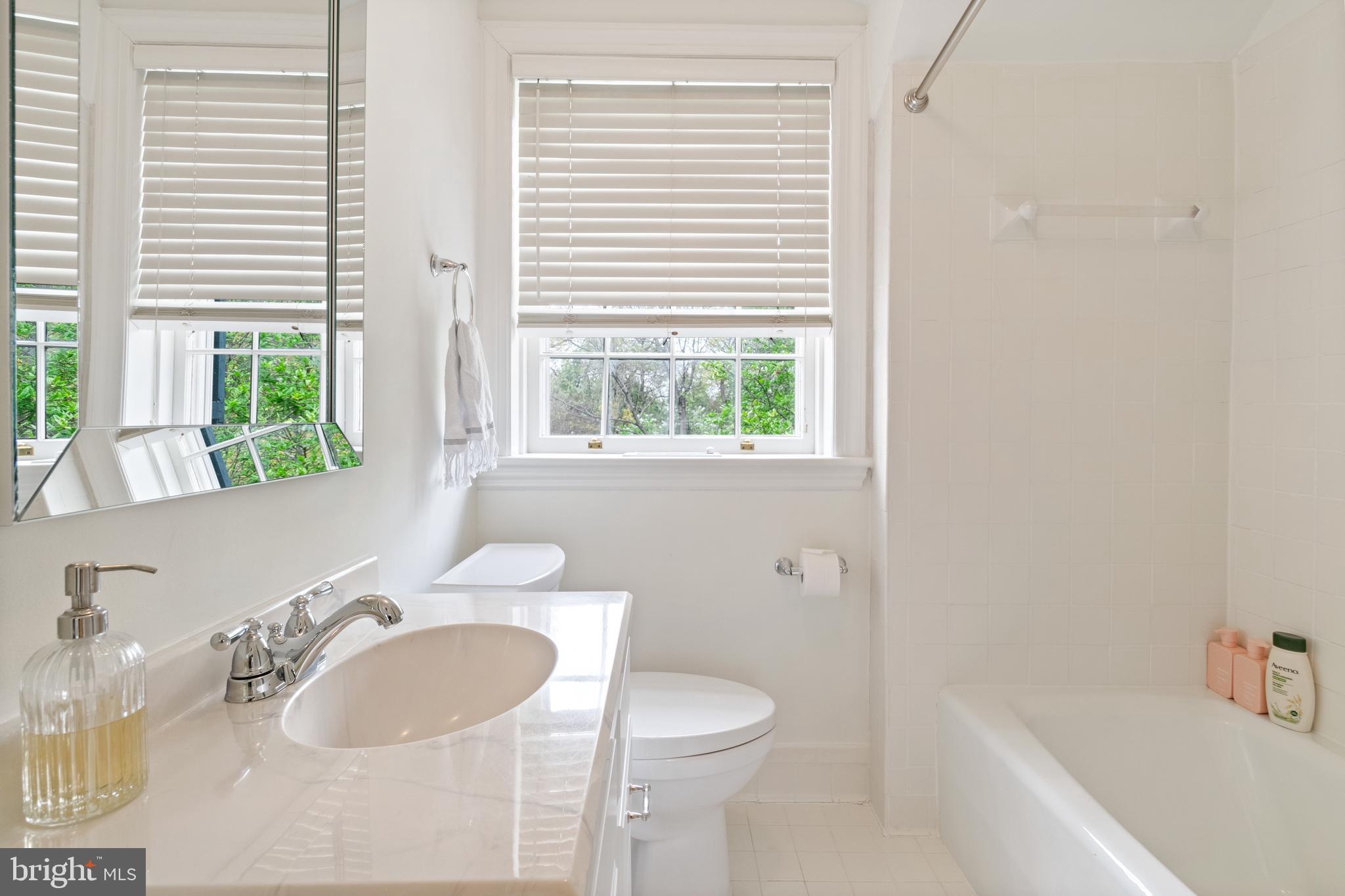 211 Lambeth Road Baltimore, MD 21218 - Photo 42 of 55 a bathroom with a granite countertop sink and a large mirror