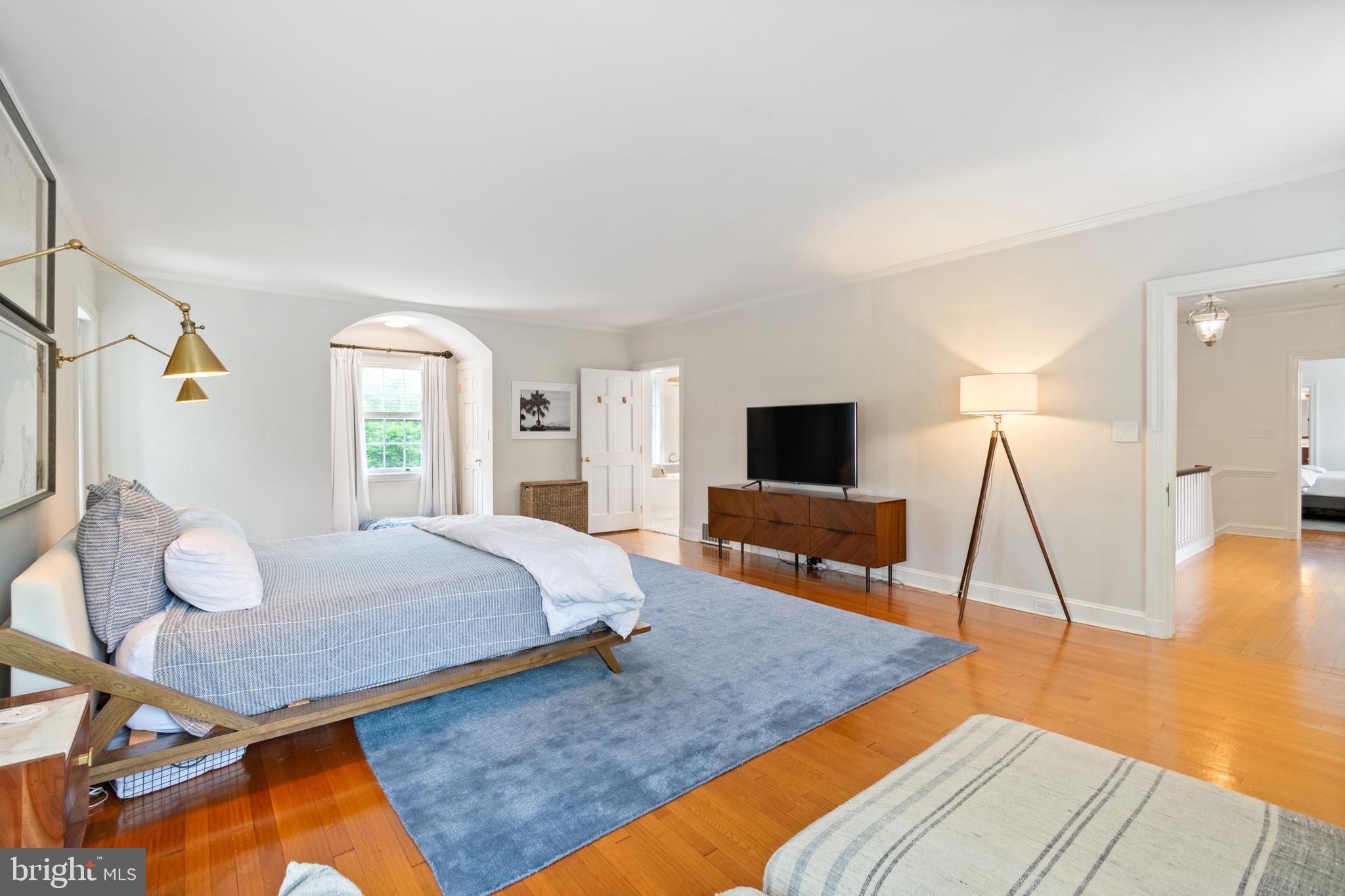 211 Lambeth Road Baltimore, MD 21218 - Photo 43 of 55 a bedroom with a bed and wooden floor