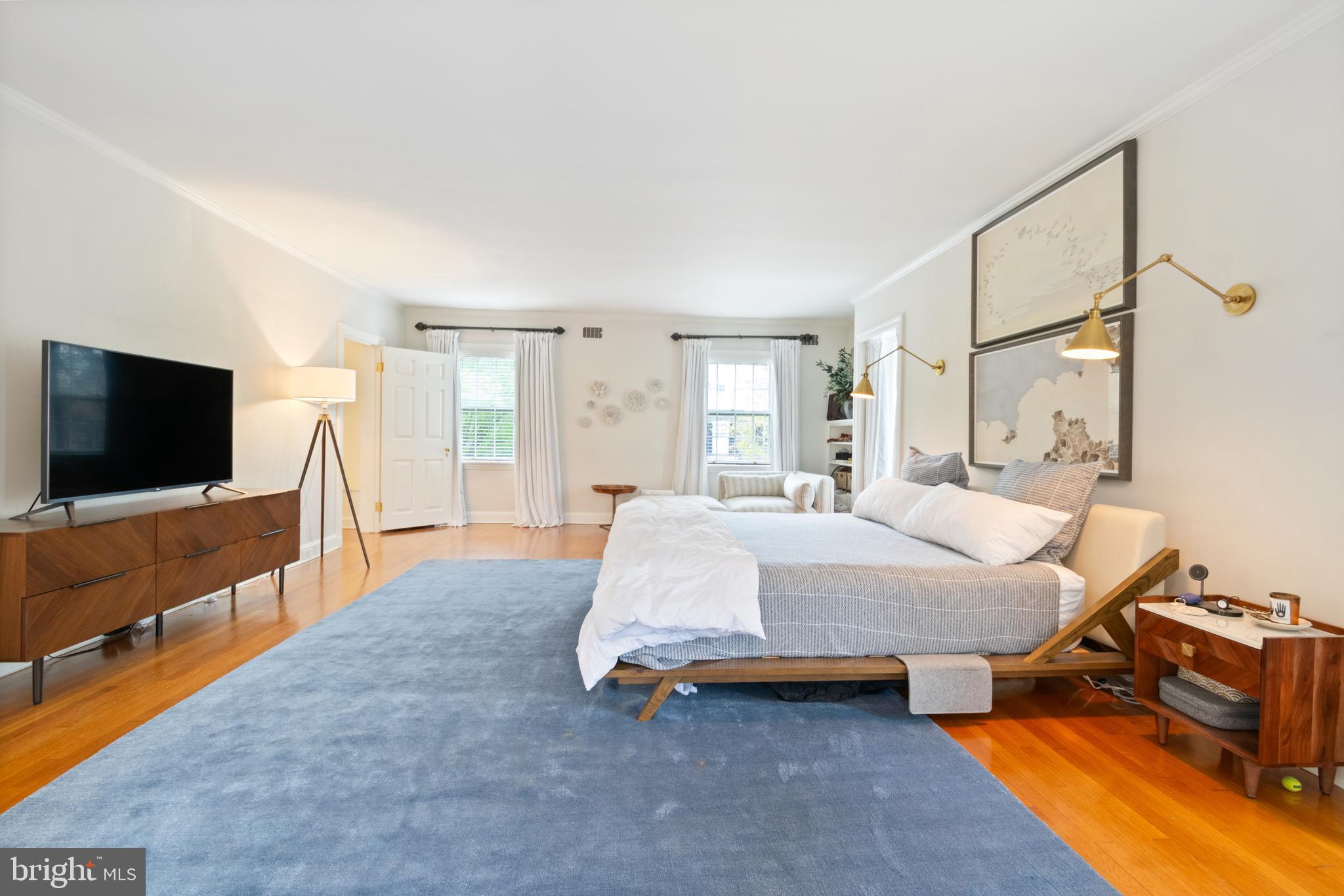 211 Lambeth Road Baltimore, MD 21218 - Photo 46 of 55 a spacious bedroom with a bed and a flat screen television