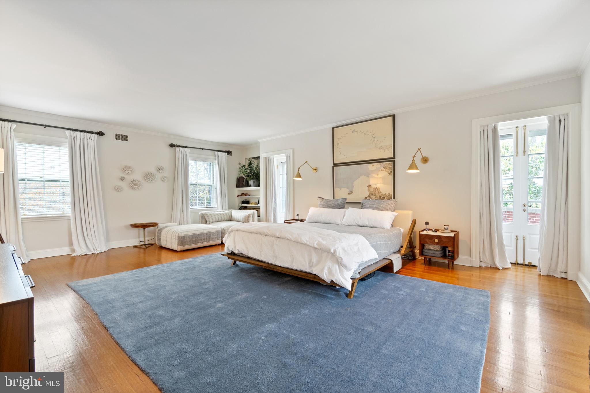 211 Lambeth Road Baltimore, MD 21218 - Photo 47 of 55 a bedroom with a bed and wooden floor