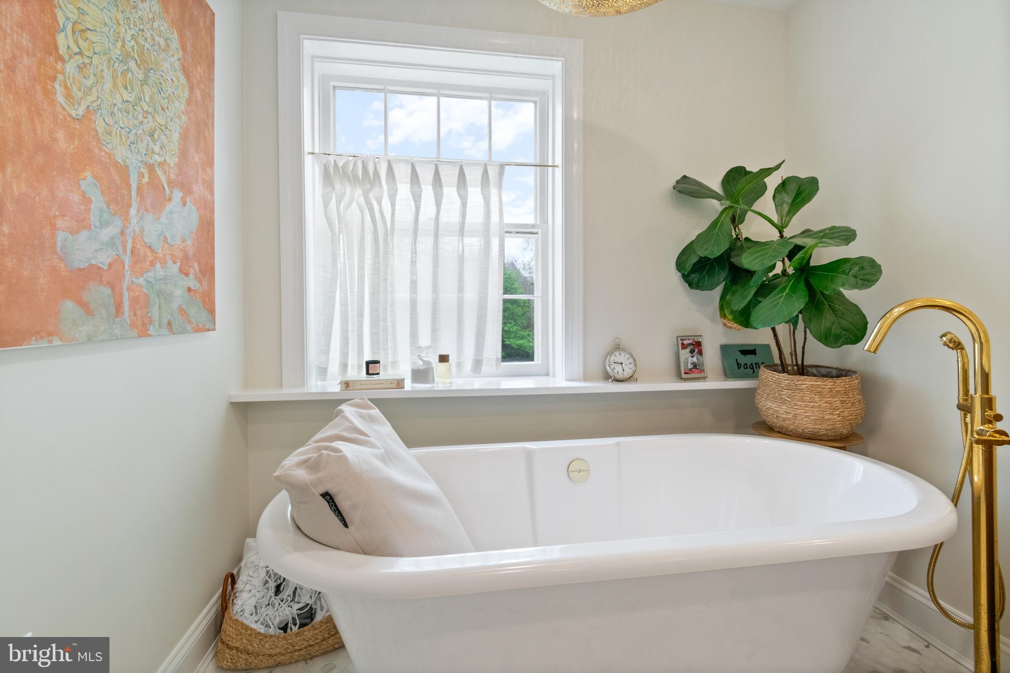 211 Lambeth Road Baltimore, MD 21218 - Photo 51 of 55 a white bath tub sitting in a bathroom next to a window