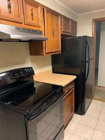 a kitchen with stainless steel appliances granite countertop a refrigerator and a stove