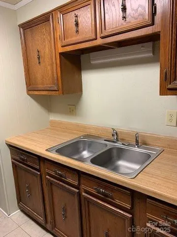a kitchen with granite countertop a sink and cabinets