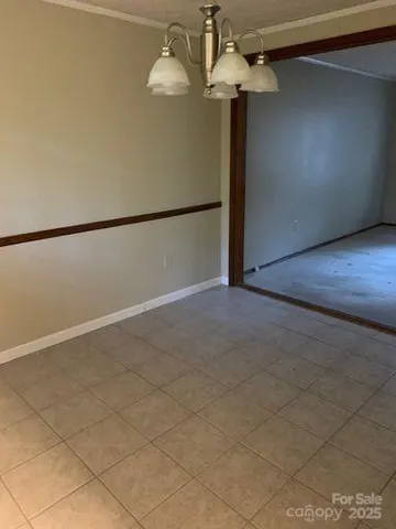 a view of a livingroom with a ceiling fan and window
