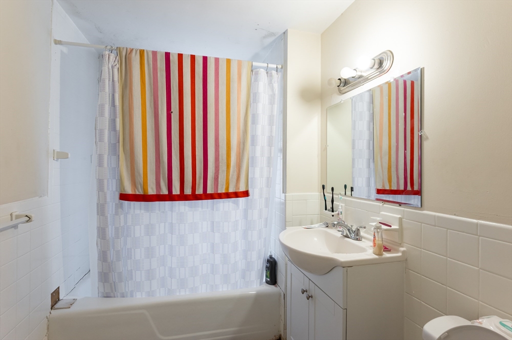 18 Edson Street Lowell, MA 01851 - Photo 11 of 41 a bathroom with a sink and a mirror