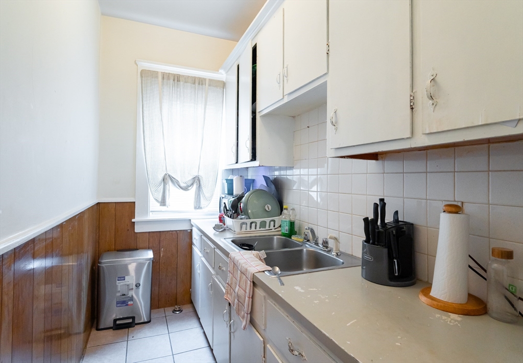 18 Edson Street Lowell, MA 01851 - Photo 12 of 41 a kitchen with a sink and cabinets