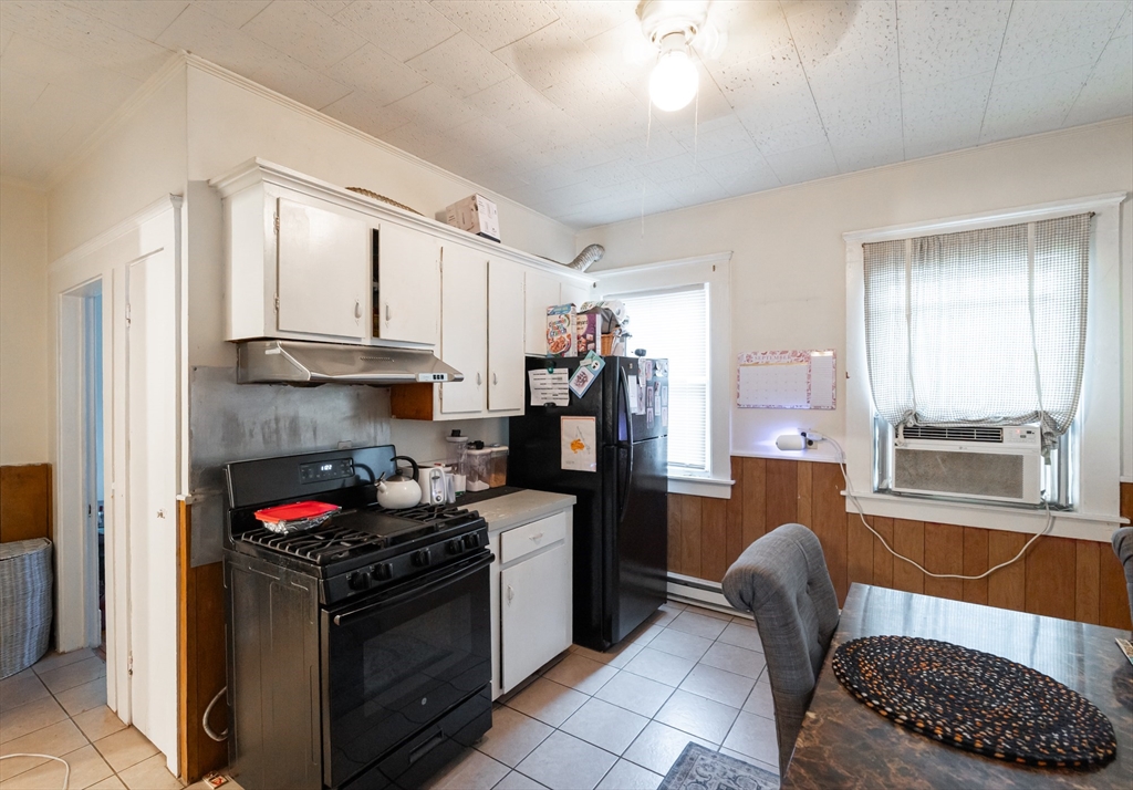 18 Edson Street Lowell, MA 01851 - Photo 14 of 41 a kitchen with granite countertop a stove and a refrigerator