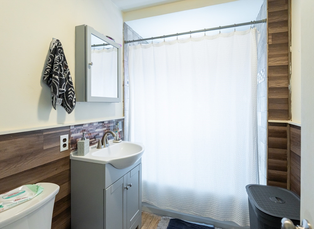 18 Edson Street Lowell, MA 01851 - Photo 15 of 41 a bathroom with a sink toilet and shower