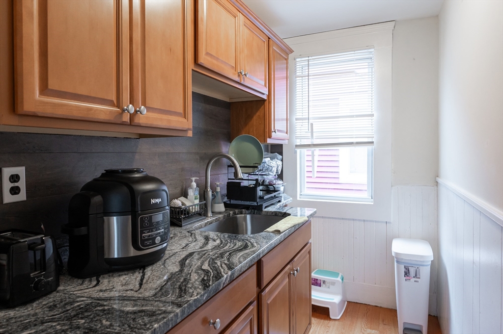 18 Edson Street Lowell, MA 01851 - Photo 17 of 41 a kitchen with stainless steel appliances a sink a stove and cabinets