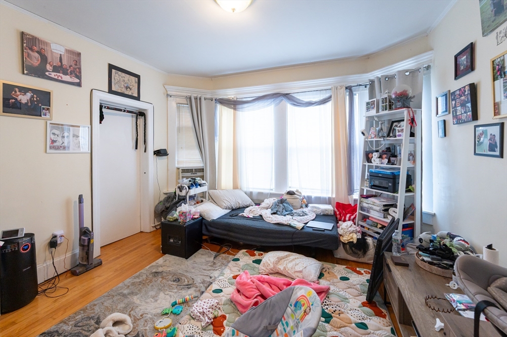 18 Edson Street Lowell, MA 01851 - Photo 26 of 41 a bedroom with furniture and a bed