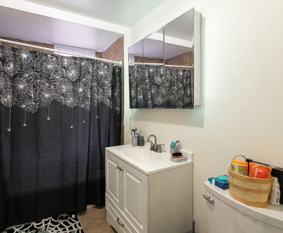 18 Edson Street Lowell, MA 01851 - Photo 27 of 41 a bathroom with a sink toilet and shower