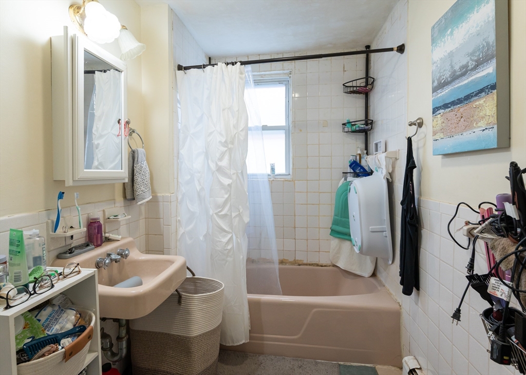 18 Edson Street Lowell, MA 01851 - Photo 30 of 41 a bathroom with a sink toilet and shower
