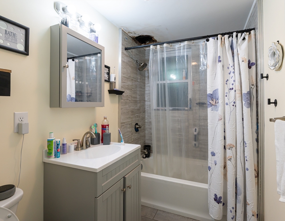 18 Edson Street Lowell, MA 01851 - Photo 3 of 41 a bathroom with a sink and a mirror